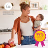 Image of mum holding baby and using Freestyle Hands Free breast pump